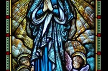 Intricately detailed stained glass panel of the Virgin Mary