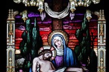 Stained glass panel with the heartbreaking image of Mary holding new crucified son
